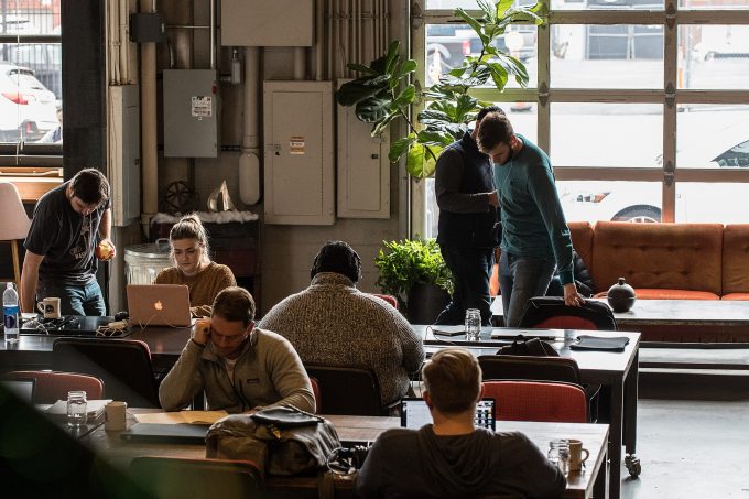 People working at computers in a coworking space