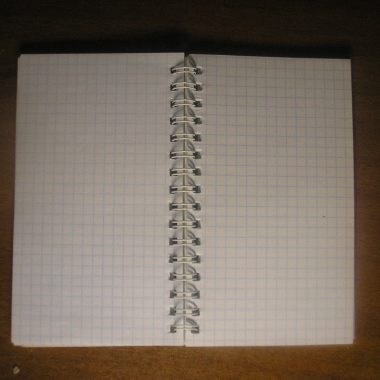 An open notepad with blank pages