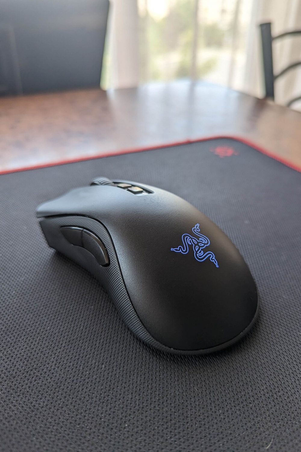 A large black mouse mat on a desk