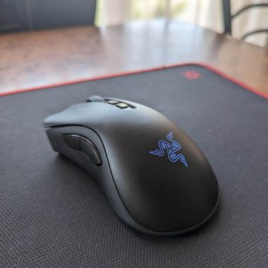 A large black mouse mat on a desk
