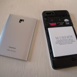An opened Fairphone showing its battery and SIM slots