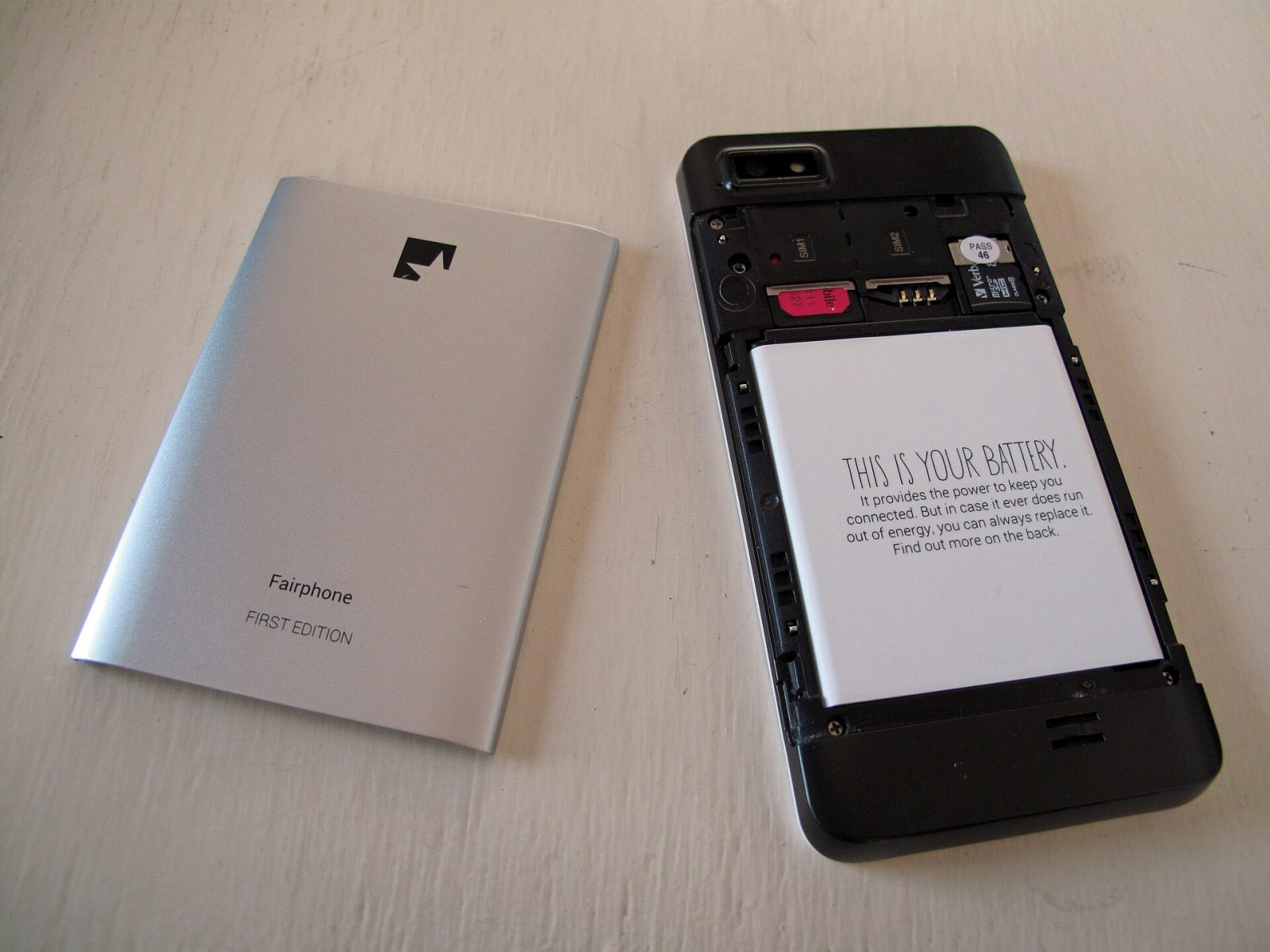 An opened Fairphone showing its battery and SIM slots