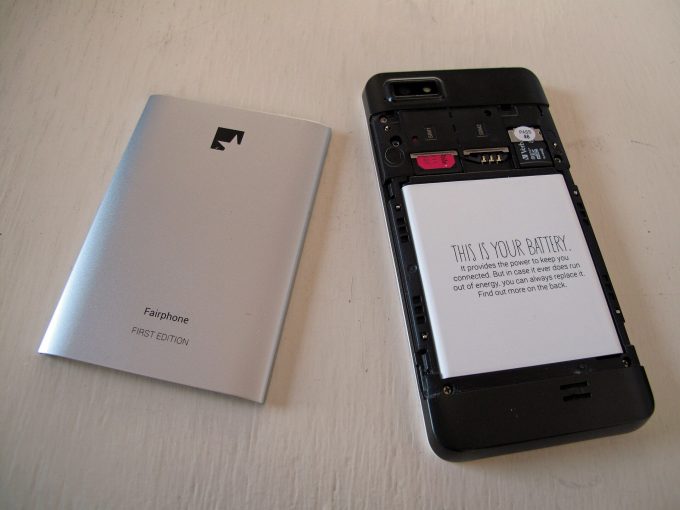 An opened Fairphone showing its battery and SIM slots