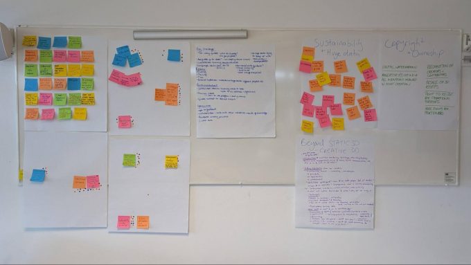 Sticky notes covering a wall during a workshop